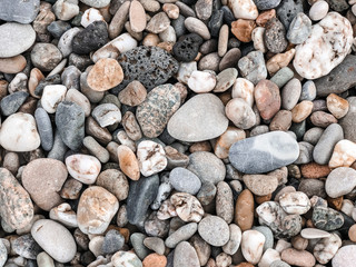 Pebbles on the Mediterranean coast. Natural background for your projects. Travel concept.