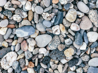 Pebbles on the Mediterranean coast. Natural background for your projects. Travel concept.