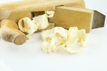 Detail of traditional wooden jack-plane with shavings isolated on white background. Old hand jack plane and wood chips.