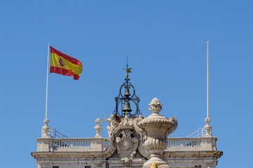 High Facade Of The Royal Palace Of Madrid Waving The Spanish Flag In The Wind. June 15, 2019....