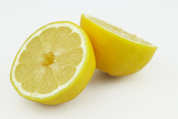 Fresh lemons halves isolated on white background. Yellow fresh sliced lemon separated on white...