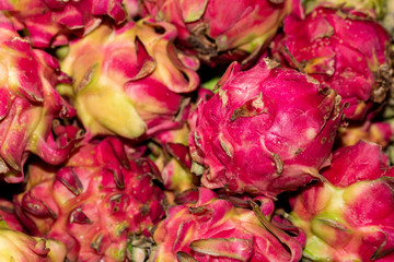 Shriveled dragonfruit piled up in a market