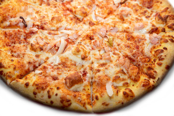 A closeup of delicious BBQ homemade pizza with double cheese, chicken, onion and bacon. Intense colors. Food background concept. With place for text