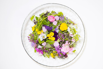 Edible flowers with young salad greens