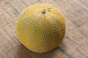 sweet, yellow melon on burlap