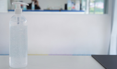 pumping alcohol gel bottle on recepteion counter with copy space