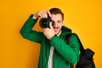 A young photographer with digital camera taking pictures.