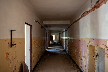 Coridor and flaking paint at abandoned derelict old building. Empty corridor in an abandoned...