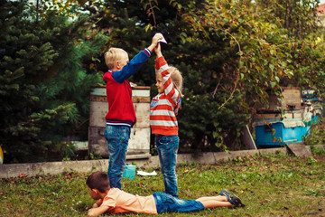 Croup of caucasian children playing fun games in nature outdoor. The concept of a happy childhood