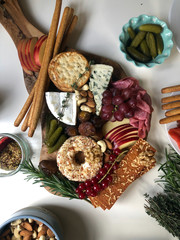 Delicious cheese board with brie, stilton, fruits, dates, nuts, salami and pickles