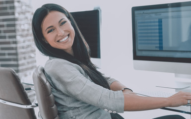 young employee of the company works with computer data.