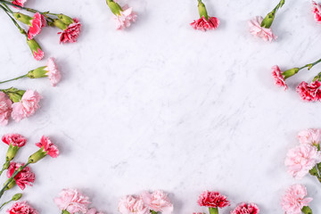Mother's Day, Valentine's Day background design concept, beautiful pink, red carnation flower bouquet on marble table, top view, flat lay, copy space.