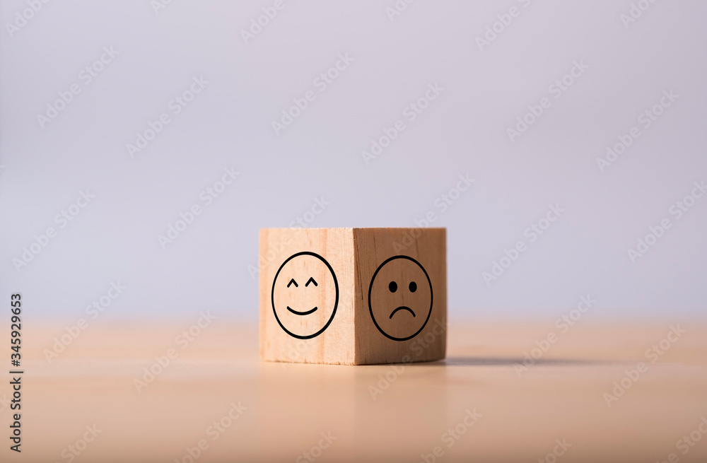 Poster two opposite side of emotion of happy and sad which print screen on wooden cubic. customer experienc