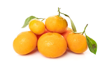 Ripe mandarines with leaves close-up on a white background