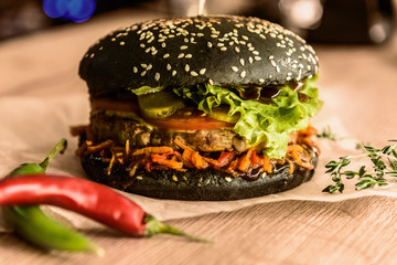 Appetizing hamburger on a table among vegetables