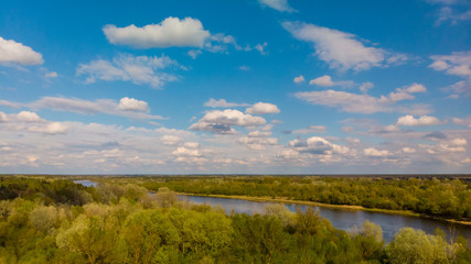 Fototapeta na wymiar Shot from the drone of the river in which the clouds are reflected