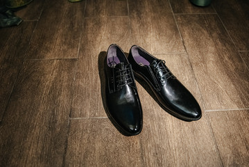 Black shoes on a dark background. Low key photo