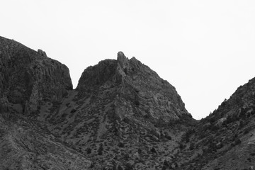 Fototapeta na wymiar Mountain under a clear sky in black and white
