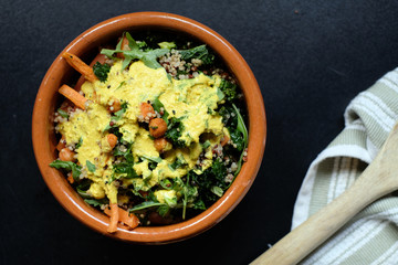 Delicious homemade chickpea salad Marrocan style with carrots, rocket leaves, quinoa and tumeric dressing