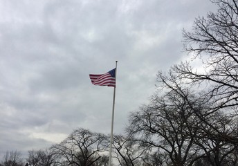 American flag against cloudy sky