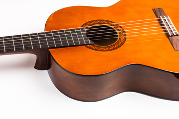 Acoustic guitar neck with body and strings on white background in close-up