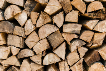Close up neatly stacked split wood pile background