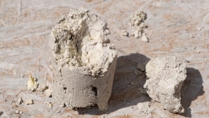 A large piece of compressed grease and dirt, which was removed from the sewer. Close-up.