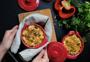 Delicious homemade mac & cheese cooked in pretty red pots