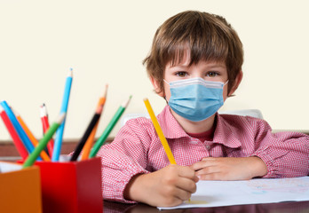 boy at school with sanitary facial mask looking at camera