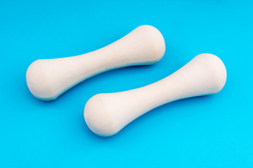 White Dumbbells on blue background top view with copy space. Fitness concept. Fitness background, healthy lifestyle.