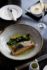 Grilled salmon served with black caviar and steamed broccoli