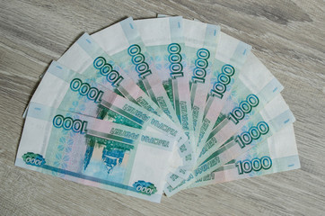 Finance, rental and new home concept - bundle of money Russian Banknotes thousand rubles on wooden...