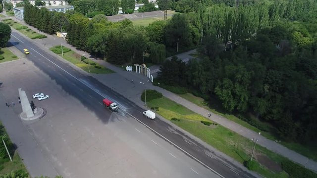 watering machine watering the roads of the city, view from the top, filming from a drone