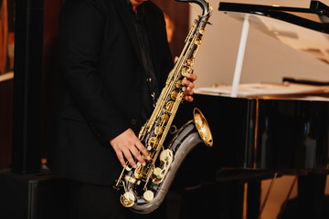 Fototapeta na wymiar Saxophone player Saxophonist playing jazz music instrument Jazz musician