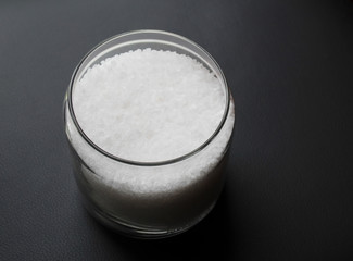 Coarse salt grains in a transparent glass jar