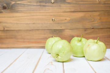Guavas on white wooden table.