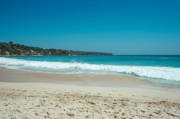 Beautiful tropical beach with waves and clear sky