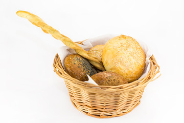 Bread basket with bread rolls and bread sticks.