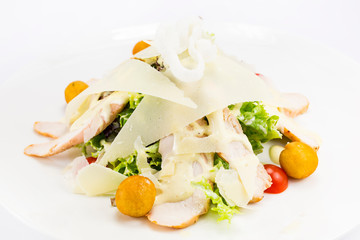 Warm salad of vegetables and meat. Close-up shot on a table in a restaurant.

