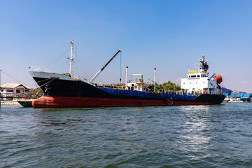 Fototapeta premium Oil tanker ship or oil cargo ship docked at port on Maeklong river Thailand