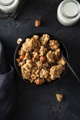 Chocolate muesli on dark background. Flat lay, top view, close up.