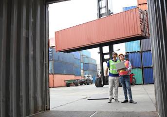 Engineering group working and they are loading container for support logistics and import export business