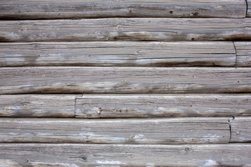 Naklejka premium The wall of an old wooden house of logs. Natural wood, rough texture.