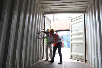Fototapeta na wymiar Engineering group working and they are loading container for support logistics and import export business