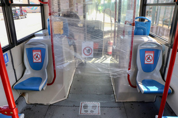 Bus with seat restriction due to the covid-19 coronavirus pandemic. The signs in Italian warn that some seats cannot be occupied to respect the distance between people. Puglia, Italy - 04/05/2020