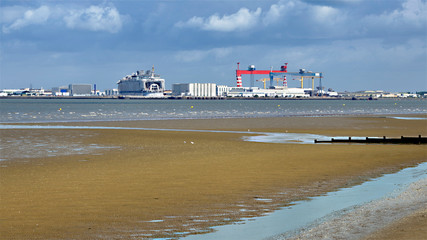 Fototapeta premium Saint Nazaire seen from of the beach at low tide of Saint Brevin les Pins in Pays de la Loire region in western France