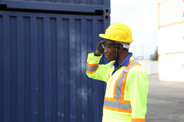 Close up of An African American handsome black engineer he is working in container box yard area
