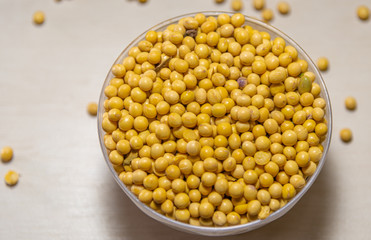 Bowls with soy beans and pods (glycine max) on light background