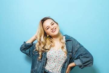 Portrait of a happy young woman presenting gestures and smiling over background