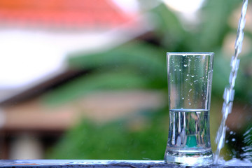 pouring water into glass